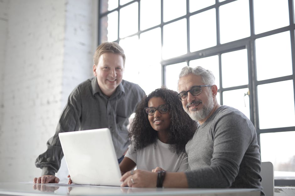 Group of diverse professionals collaborating in a modern, bright office space.